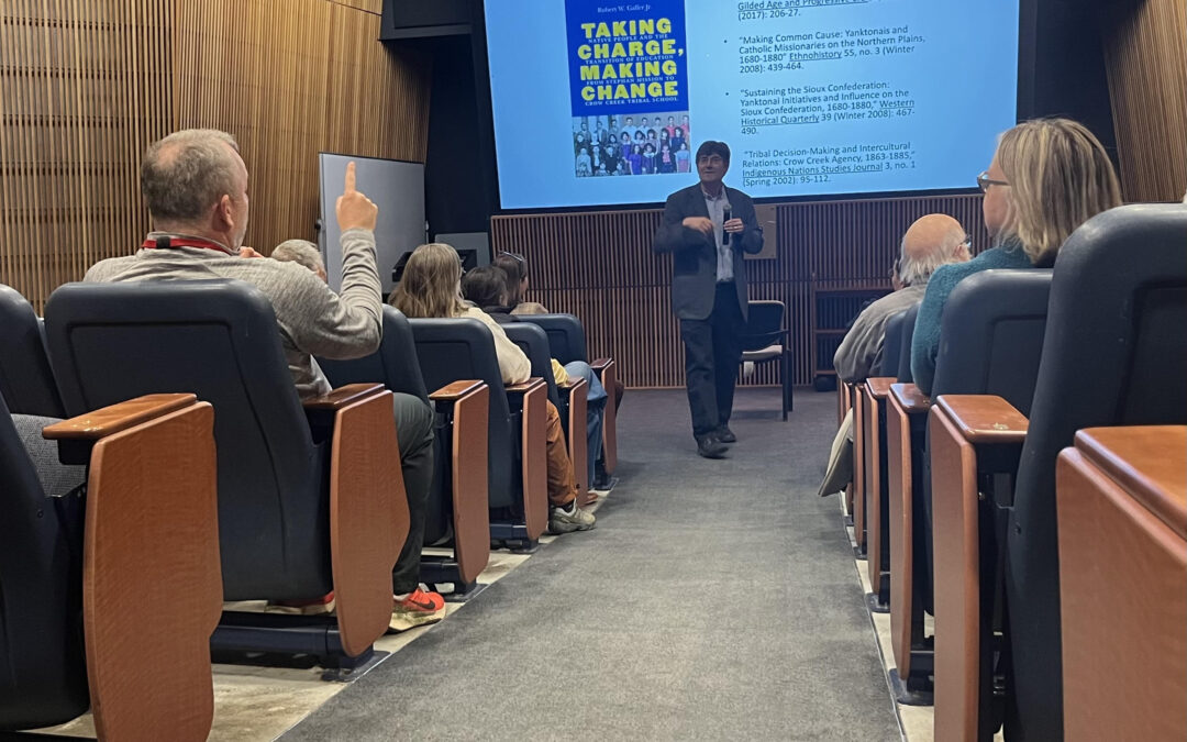 Dr. Robert W. Galler speaking to a crowd at St. Cloud State University