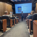 Dr. Robert W. Galler speaking to a crowd at St. Cloud State University